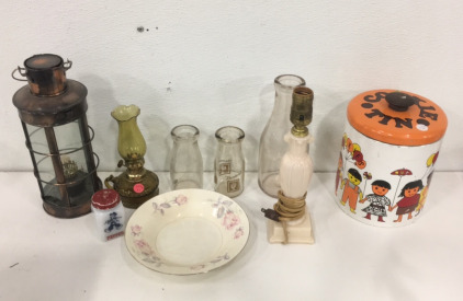 (1) Vintage Ransburg Metal Cookie Tin With Lid (1) Antique Electric Lamp (1) 1/2 Pint Milk Jugs (1) 1-Qt Glass Milk Jug (1) Glass Pepper Shaker (1) Vintage Oil Lamps