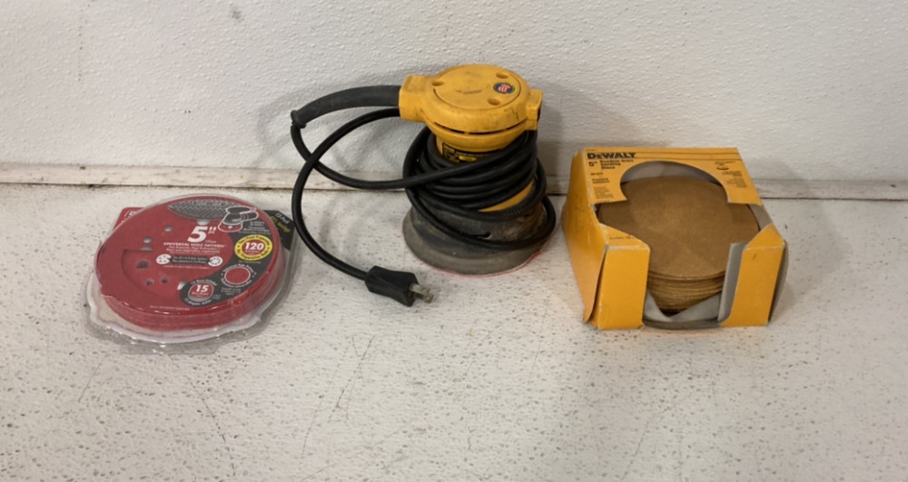 (1) Dewalt DW420 Random 5’’ Orbit Palm Sander, (2) Packages Of 5’’ Orbit Sander Sandpaper