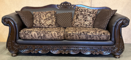 FANCY DARKWOOD AND LEATHER-LIKE LOVESEAT WITH CUSIONS- PLEASE INSPECT