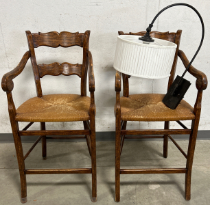 2 WOODEN CHAIRS WITH WICKER SEATS AND AN INDOOR WALL SCONCE