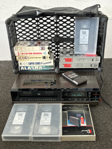 WORKING VINTAGE MAGNAVOX VCR WITH WORKING REMOTE AND COVER, 11 VHS CASSETTES AND VIDEO RECORDER CLEANER