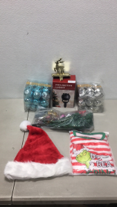 (1) A.T Lums Christmas LED Light Projector (68) Ball Type Christmas Ornaments (1) Santa Clause Stocking Cap (1) Kids Size 14 Grinch Pajamas