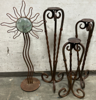 3 WRAUGHT IRON CANDLE PILLAR STANDS (S/M/L 30”, 36” & 42”) AND A WRAUGHT IRON SUN CANDLE PILLAR (46” TOP TO BOTTOM)