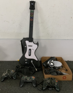 (2) XBOX CONTROLLERS, (1) LOGITECH CONTROLLER, (1) BLOCKHEAD GAME GUITAR AND MORE
