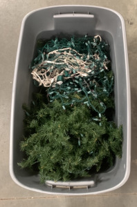 BIN OF CHRISTMAS LIGHTS (ALL LIGHTS POWER ON) AND FAKE WREATH MATERIAL