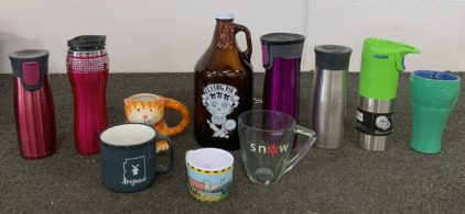 (5) METAL HOT DRINK PORTABLE CUPS, (1) CERAMIC TO GO MUG WITH LID, (2) CERAMIC MUGS, (1) GLASS MUG, (1) PLASTIC MUG, (1) FLYING PIE 64 FL OZ GLASS JUG