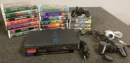 PS2 WITH CONTROLLERS (POWERS ON), 13 VHS TAPES, AND 7 PS2 GAMES