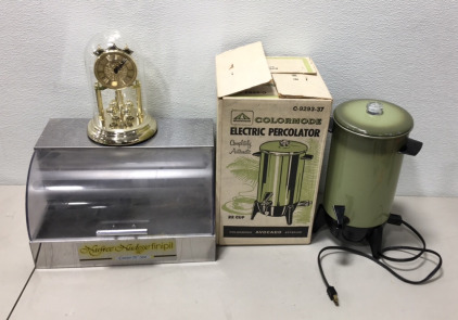 (1) Vintage Aluminum Colormode Electric Percolator With Original Box (1) 15” x 10” Nufree Cover And See Bakery Display (1) Loricron West Germany Mantle Clock