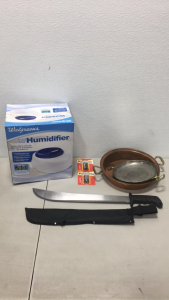 (1) 18” Machete With Sheath (1) Walgreens Cool Mist Humidifier In Original Packaging (2) Vintage Cast Pans (2) Packs Of Panasonic AA Batteries