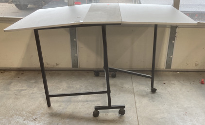 (1) WHITE FOLD OUT TABLE (MISSING ONE WHEEL)