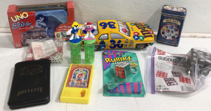 (1) UNO &ldquo;Elvis&rdquo; Special Edition New (1) M & M&rsquo;s #36 Tin (1) Tin 24 Assorted Dice (1) Sudoku on a Puzzle Cube (1) Rubik&rsquo;s Cube Key Chain & More!