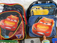 2 LIGHTNING MCQUEEN BACKPACKS, VINTAGE KEN DOLL, BACKSTREET BOYS BOOK, ELECTRIC PUTTING PARTNER, TOY SKATEBOARD AND BABY DOLL - 2