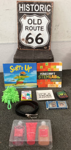 STORAGE BIN INCLUDING 1 HISTORIC OLD ROUTE 66 SIGN, (1) SURFS UP BOOK, (1) MINECRAFT STEMLAB BOOK, (1) MULTIPLICATION CARD SET, (1) LEATHER BELT, (1) SPA WORKSHOP LOTION AND BATH SET AND MORE