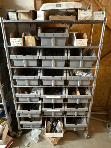 LARGE LOT OF BINS WITH DOOR STRIKE PLATES, LATCHES, METAL POLE SOCKETS AND MORE (SHELVING NOT INCLUDED)