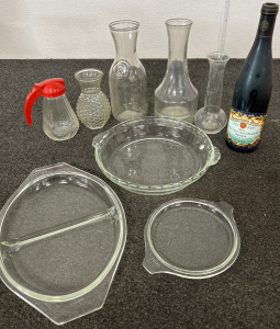 PYREX GLASS PIE DISH, PYREX GLASS DIVIDED SERVING DISH, SMALL PYREX GLASS LID, (2) GLASS CARAFES, (2) SMALL GLASS VASES, GLASS SYRUP POURER AND DECORATIVE DARK WINE BOTTLE (EMPTY)