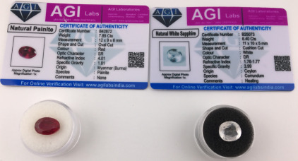 (2) Certified Natural Gemstone&rsquo;s W/COA Including (1) 6.40 ct. Cushion Cut White Sapphire (1) 7.85 ct. Oval Cut Red Painite