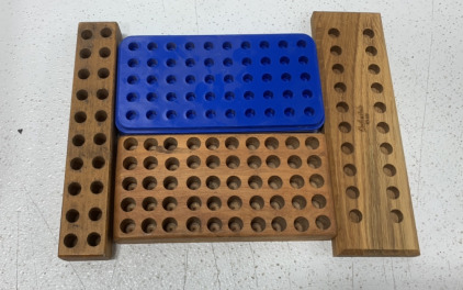 (3) WOODEN BULLET STORAGE PIECES WITH (1) PLASTIC BULLET STORAGE