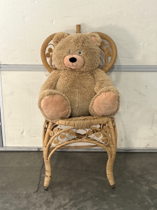 STUFFED BEAR AND WICKER CHAIR