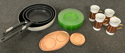 3 NON-STICK SKILLETS (8”, 10”, 12”), 7 GREEN GLASS SMALL PLATES, 4 CERAMIC CUPS WITH REMOVABLE COPPER COLORED SLEEVES, COPPER COLORES SMALL TRAY AND 4 COPPER COLORED COASTERS