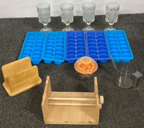 FOUR WINE GLASSES, FIVE ICE CUBE TRAYS, TWO WOODEN NAPKIN HOLDER, CITRIS JUICER