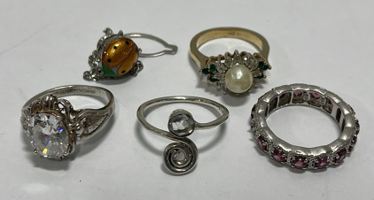 (1) Clear Gemstone.925 Silver Ladies Ring Size 8, (1) Clear Gemstone .925 Silver Ladies Ring Size 8-1/2, (1) Pink Gemstone Ladies Ring Size 7-1/2, (1) Gold Toned W/ Pearl And Green And White Gemstones Ladies Ring Size 7, (1) Ladybug Tie Clip