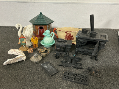 MINATURE CAST IRON STOVES, VINTAGE AVON BATH OIL GLASS PITCHER WITH BASE (EMPTY), WOODEN FIGURES AND MORE