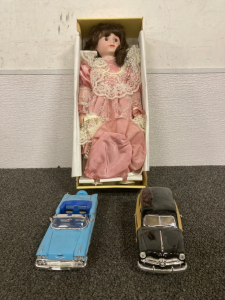 CONNOISSEUR COLLECTION PORCELAIN DOLL FROM SEYMOR MANN, (2) VINTAGE DIE CAST CARS