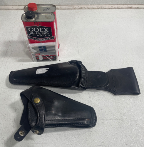 (2) Gun Holsters (2) Cans of Goex Black Rifle Powder (1) Box of Shotshells