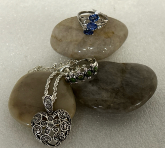 SILVER TONE RING WITH 3 BLUE CENTER STONES (SIZE 6), SILVER TONE RING WITH 5 GREEN STONES (SIZE 9) AND SILVER TONE HEART PENDANT NECKLACE WITH SILVERY-BLACK STONES