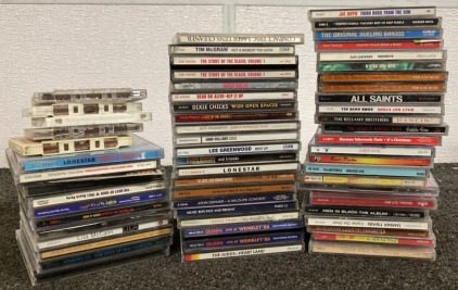 BOX OF CDS INCLUDING QUEEN, SHANIA TWAIN, THE CLASH, JOHN DENVER, TIM MCGRAW, YOUNG GUNS, GUNS N&rsquo; ROSES AND MORE