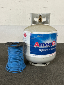 SPOOL OF BLUE ELECTRICAL WIRE AND A 5 GALLON PROPANE TANK