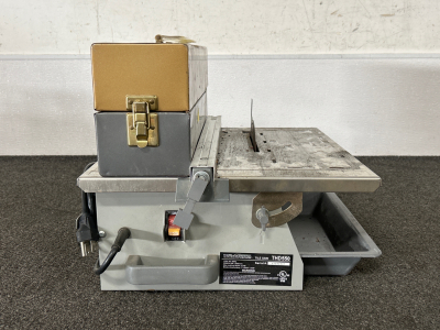 WORKFORCE TILE SAW (POWERS ON) AND METAL BOX