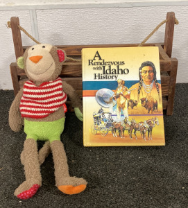 (1) WOODEN BASKET GARDEN, (1) SIGIKID STUFF TOY, AND (1) “A RENDEZVOUS WITH IDAHO HISTORY” BOOK