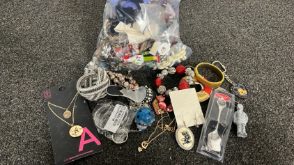 BAG OF PINS, BRACELETS, KEYCHAINS, AND MORE