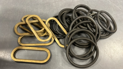 BLACK RUBBER RINGS AND BRASS LIKE OVAL RINGS