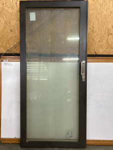 SLIDING GLASS DOOR IN DARK BROWN TRIM WITH LOCKING HANDLE: 29-21/32&rdquo;x73-11/32&rdquo;x2.5&rdquo;