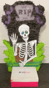 (1) “R.I.P.” GRAVE STONE SKELETON PINATA (38”X23”), WITH (1) PAIR OF JUST FAB MCKINLEY BROWN BOOTS (US 8)