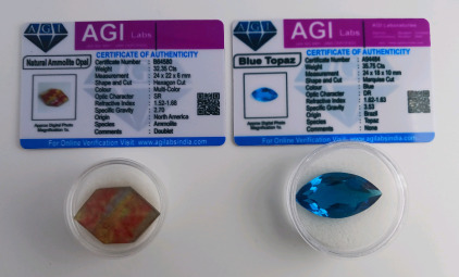 (1) 32.35 ct. Multicolor Ammolite Opal w/COA (1) 35.75 ct. Brazilian Blue Topaz w/COA