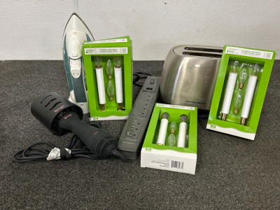 BATTERY OPERATED CANDLE LAMPS, HAMILTON BEACH TOASTER, IRON, HAIR DRYER AND PHILIPS POWER STRIP. ALL WORK/ POWER ON.