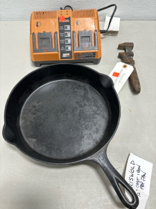 (1) 10&rdquo; Griwald CAs Iron Skillet (1) Ridgid Rapid Max Twin Battery Charger (1) Monkey Wrench