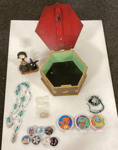 Wooden Chest Of Pins, Necklace, Kiki’s Delivery Service Figure, And Pokémon Tags