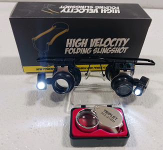 (2) High Velocity Folding Slingshots (1) 30x21mm Jewelers Loupe (1) Illuminated 20x Jewelers Glasses