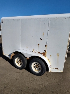 16' Enclosed Trailer Tandem Axel Double Doors with Side Rack. Shelves and Compartments Built Inside. Unit has been Winterized, Wired and Piped for Electricity and Gas. Very Well-Built Trailer