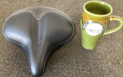 (1) Bicycle Seat, (1) Gree Smile Coffee Cup