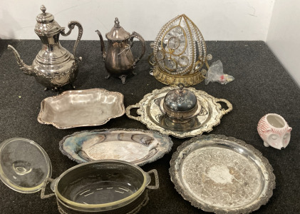 Antique Silverware Serving Plates With Teapots And A Wall Light Fixture