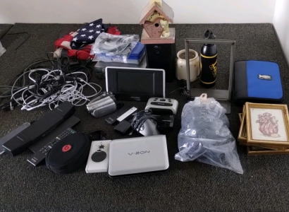 Assorted Items Including Power Banks, Panasonic Camcorder, Modem, Portable DVD Player, Alarm clock, Power Cords For Computer's, Sony Remote Control, Knee Pads