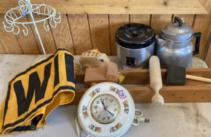 Wooden toys, a clock, some teabag and coffee maker and Sign
