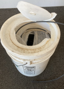 Bucket with spool of garden pipe