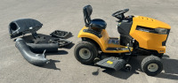 Yellow Cub Cadet Riding Lawnmower With Attachments