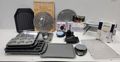 Huge assortment of kitchen baking items. Includes (2) wooden cutting boards, few different sized cupcake pans and cookie sheets, working digital Eat Smart scale and mini waffle maker